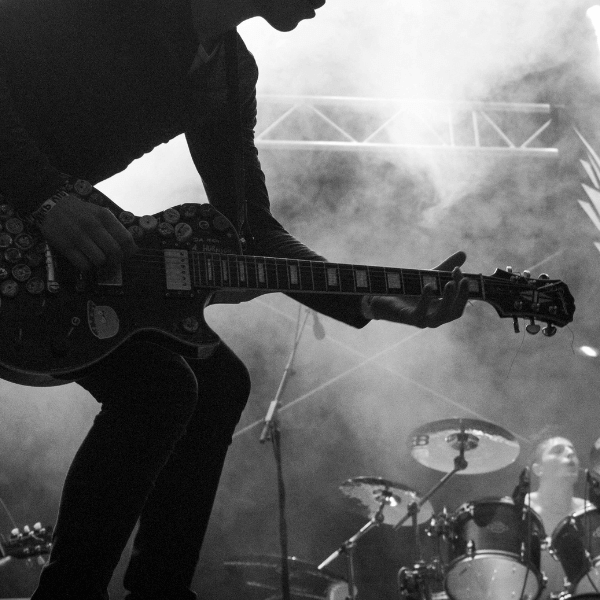 man playing a guitar on a concert